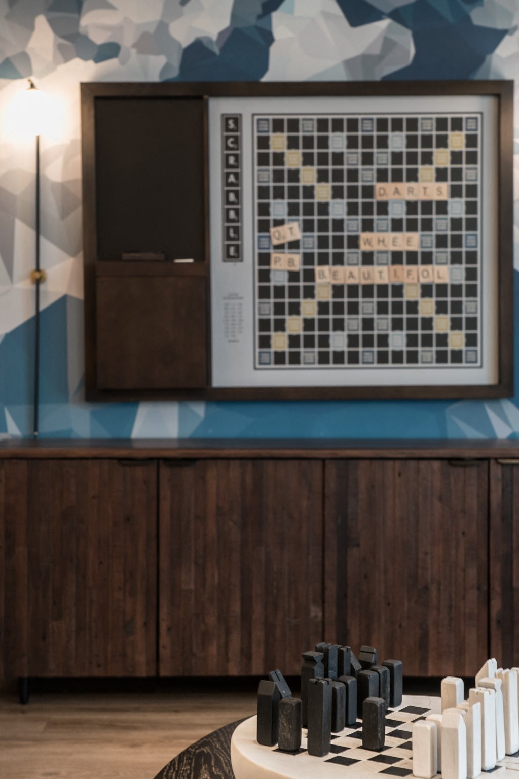 a chess board on a table in a room with a tv