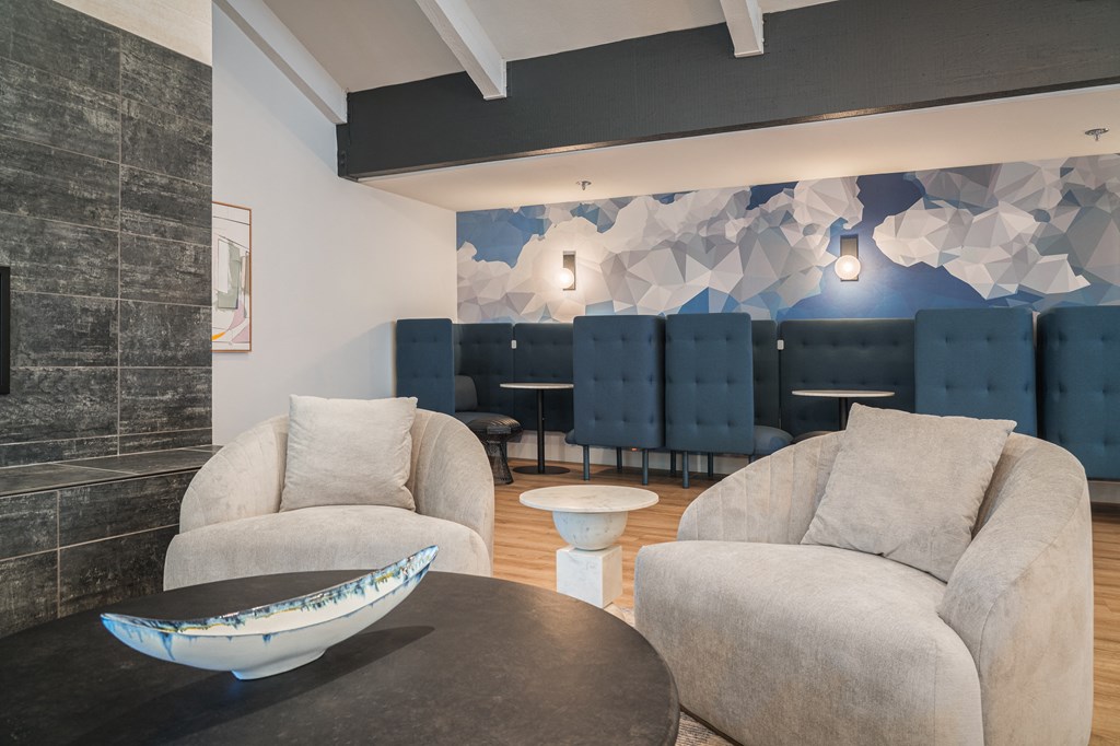 a living room with couches and chairs and a table with a bowl