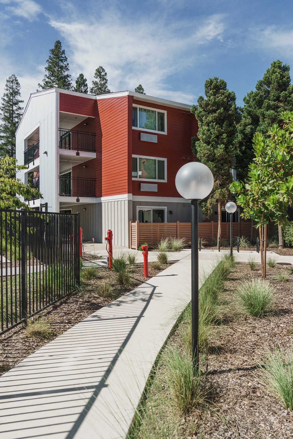 a red and white building with a sidewalk in front of it