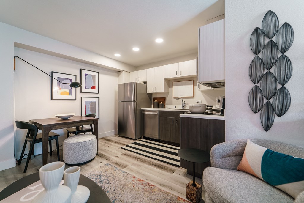 a living room with a couch and a table and a kitchen