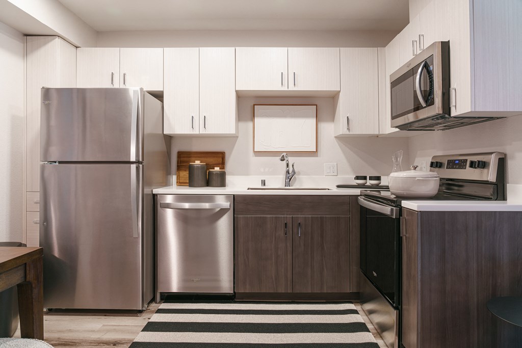 a kitchen with stainless steel appliances and white cabinets
