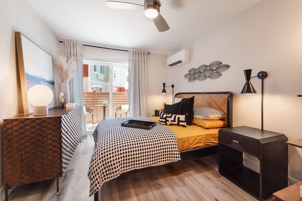 a bedroom with a bed and a large window