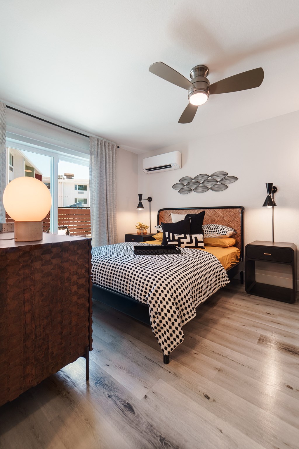 a bedroom with a bed and a ceiling fan
