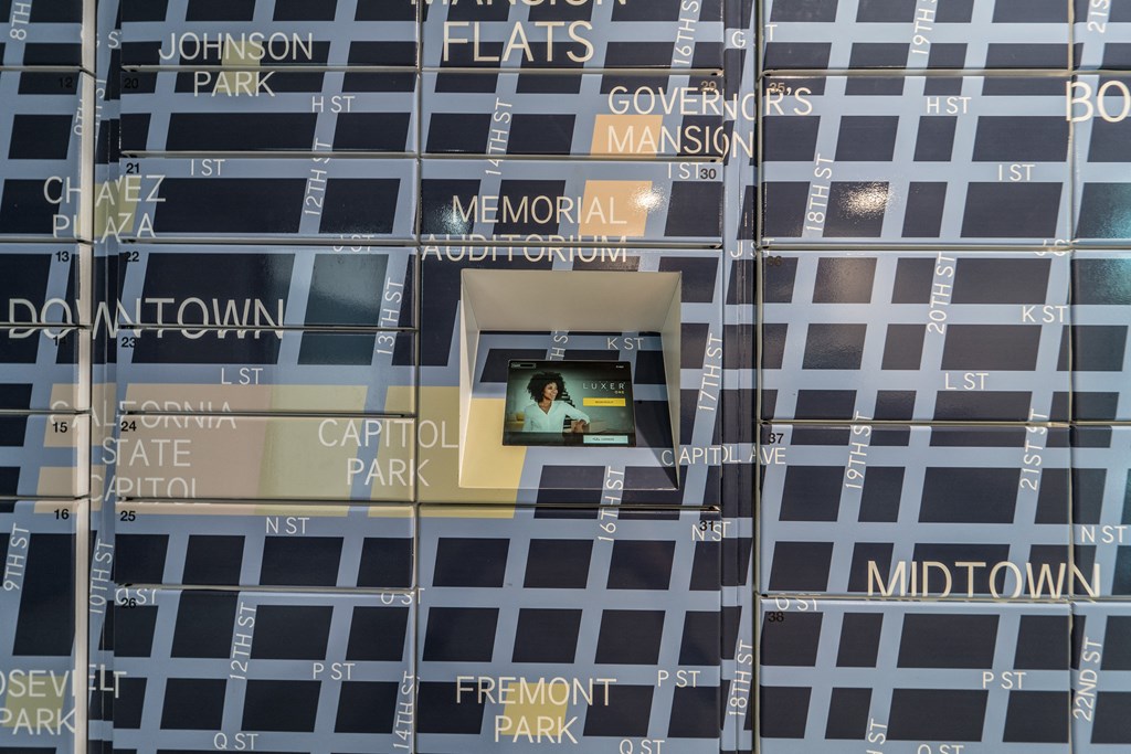 Community package locker wall painted with a large mural of a Sacramento city map  at Track 281 Apartments, California, 95811