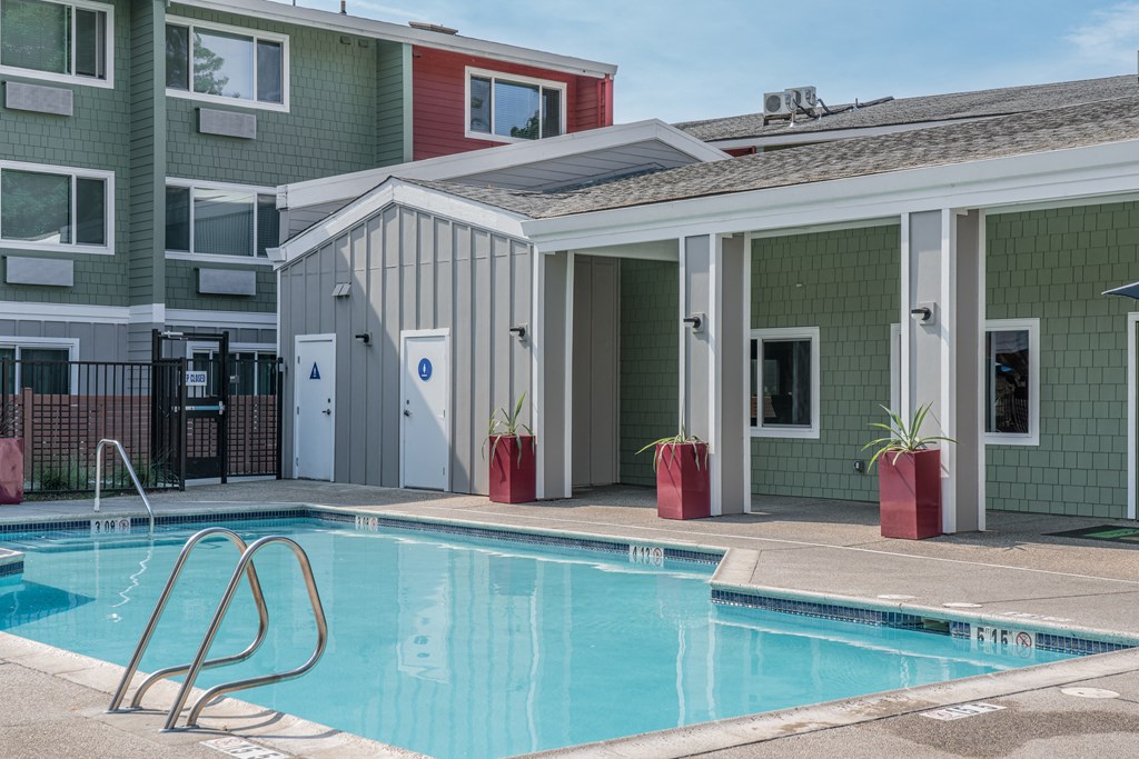 a swimming pool in front of a building with a pool