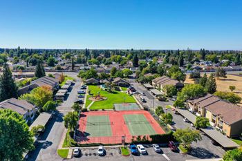 an aerial view of a neighborhood with a tennis court