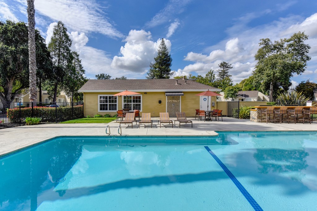 Community pool area with blue skies and clear water at Vineyard Terrace Apartments, California 94558