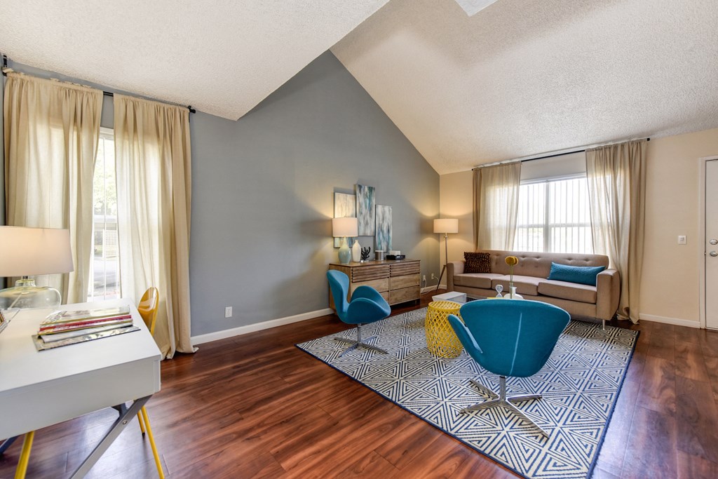 living room with hardwood inspired flooring and vaulted ceilings at Vineyard Terrace Apartments, Napa, CA