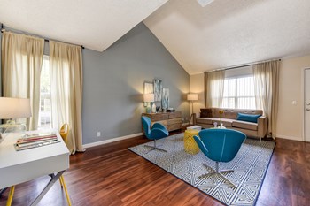Model home living room with hardwood inspired flooring and vaulted ceilings - Photo Gallery 4