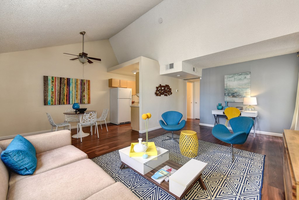 Model home living room and dining room with vaulted ceilings at Vineyard Terrace Apartments, California