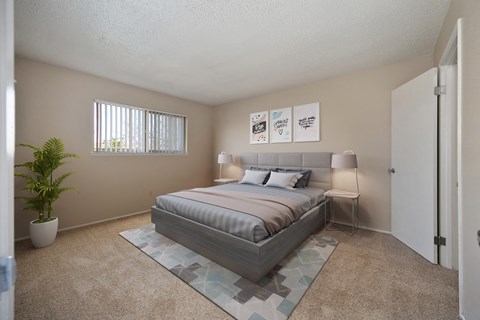 a bedroom with a bed and a potted plant
