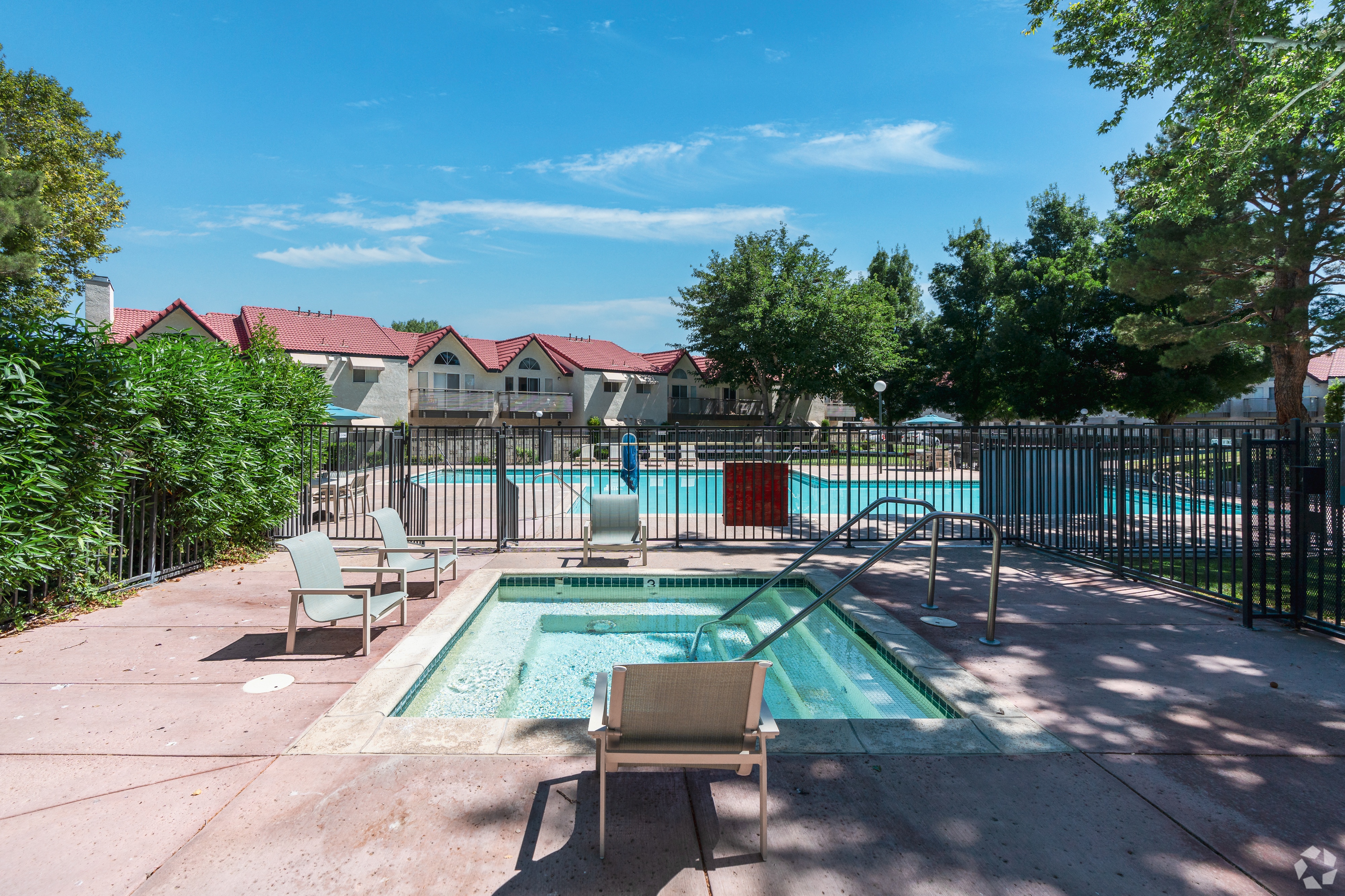 Swimming Pool and Spa with lounge chairs and area is gated