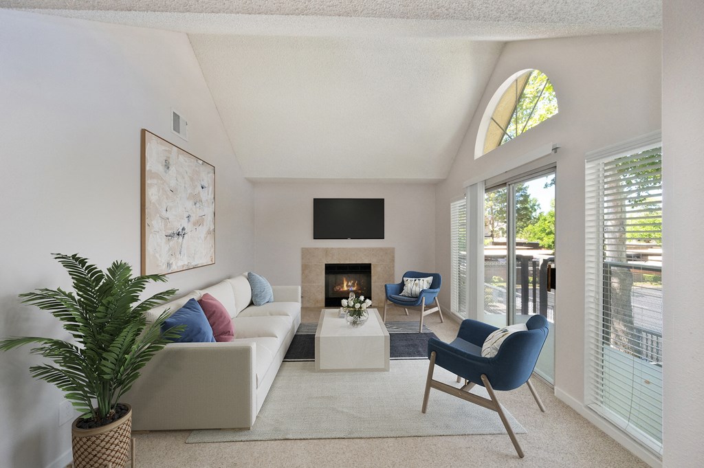 a living room with a couch and chairs and a fireplace