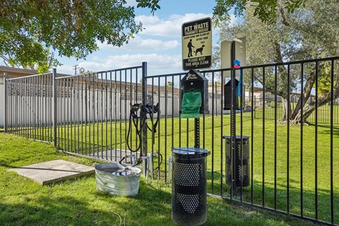 A sign on a fence reads "PET WASTE PICK UP".