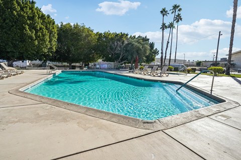 A large rectangular pool with a blue tinted water.