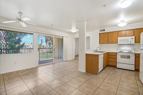 A kitchen with white appliances and wooden cabinets.