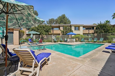 our apartments have a resort style pool with chairs and umbrellas