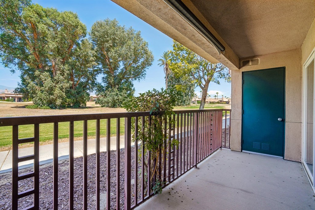 the view from the balcony of a house with a blue door