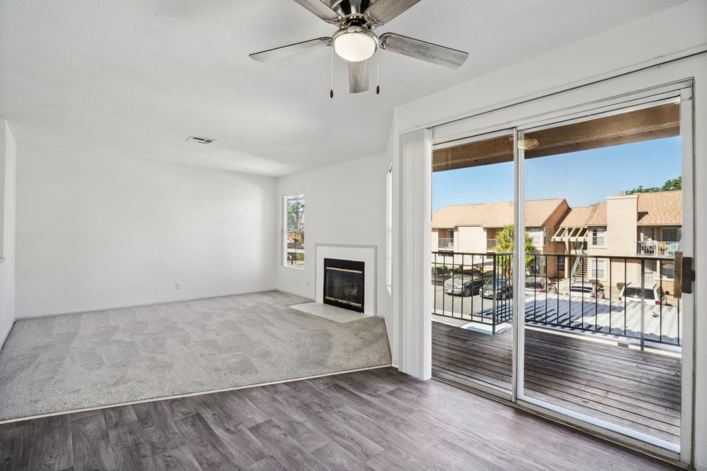a living room with a fireplace and a sliding glass door