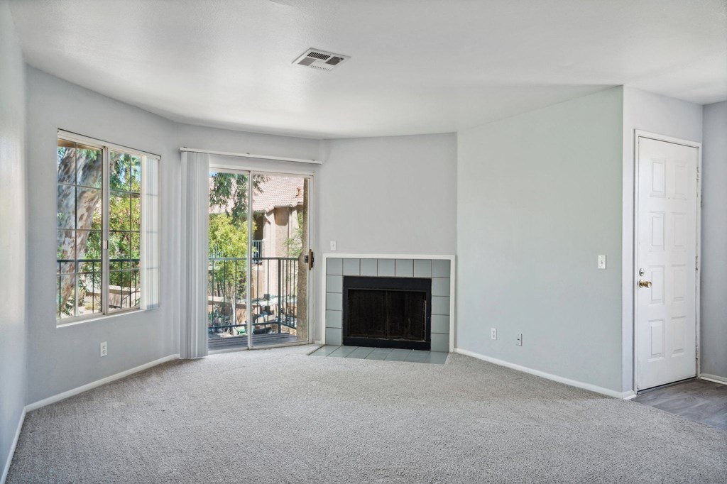 A living room with a fireplace and a door.