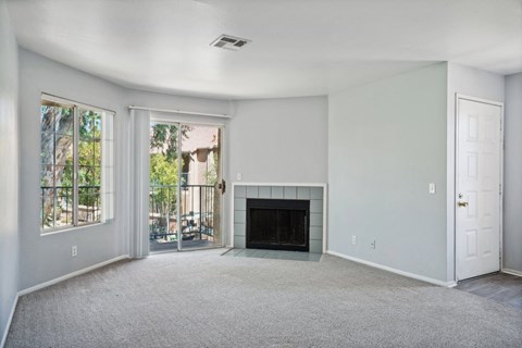 A living room with a fireplace and a door.