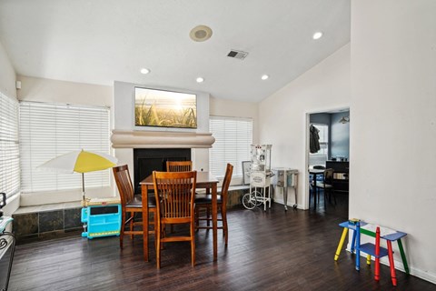 A living room with a fireplace and a painting above it.