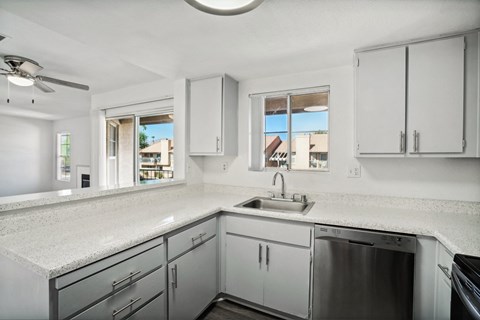 a row of windows in a white building with light shining through them