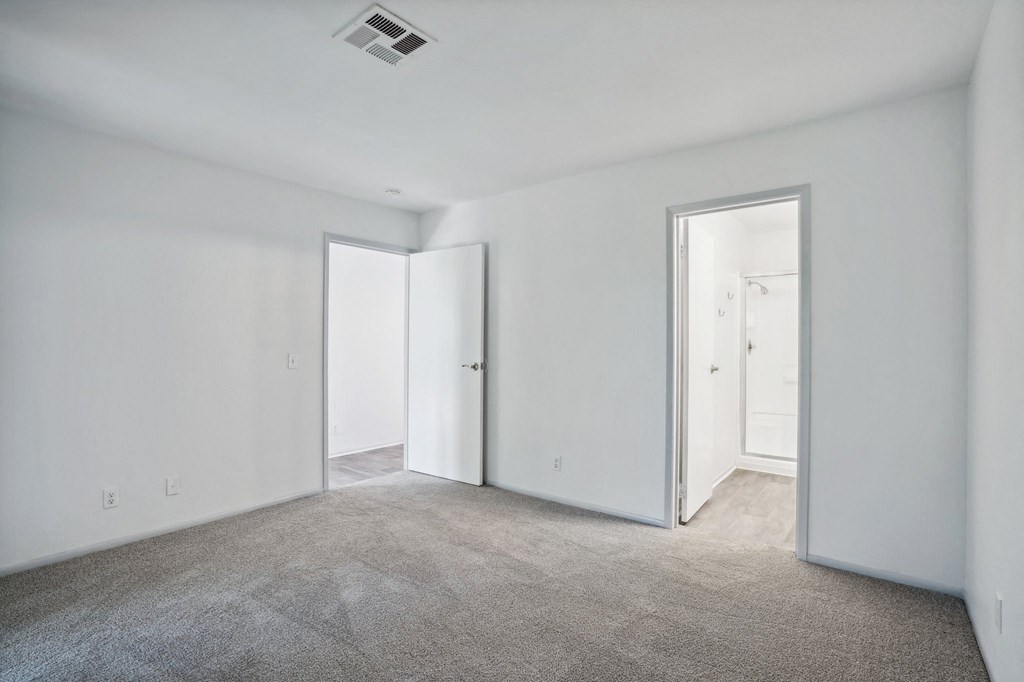 an empty living room with white walls and white doors