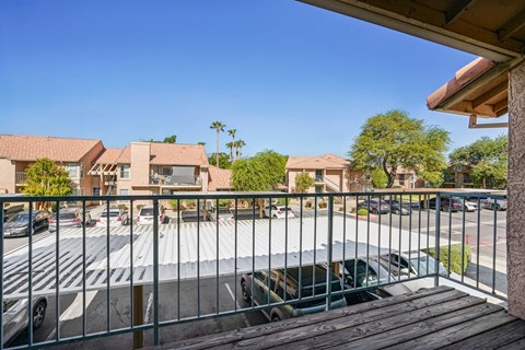 A parking lot with cars and a building in the background.