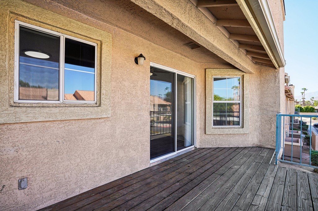a patio with a glass door and a balcony