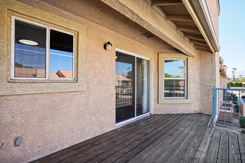 a patio with a glass door and a balcony