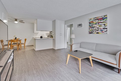 A living room with a grey couch and a wooden coffee table.