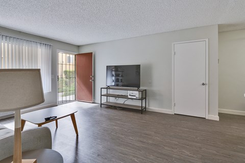 A living room with a television and a chair.