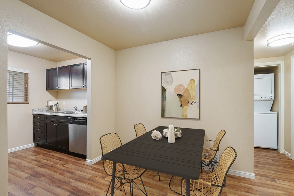 a dining room with a table and chairs and a kitchen