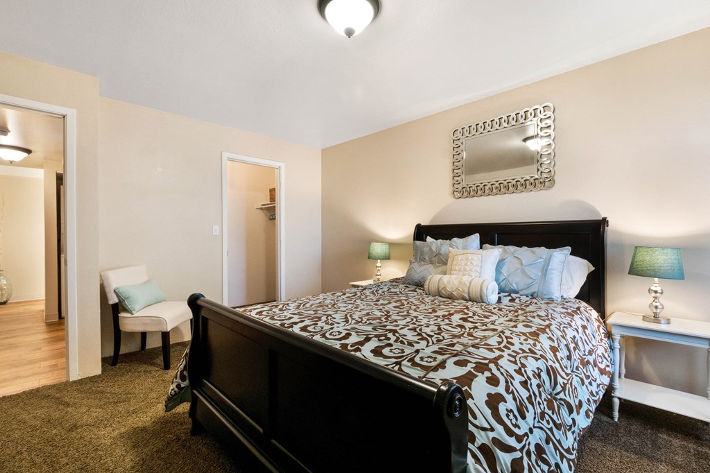 the view of a bedroom with a large bed and a closet