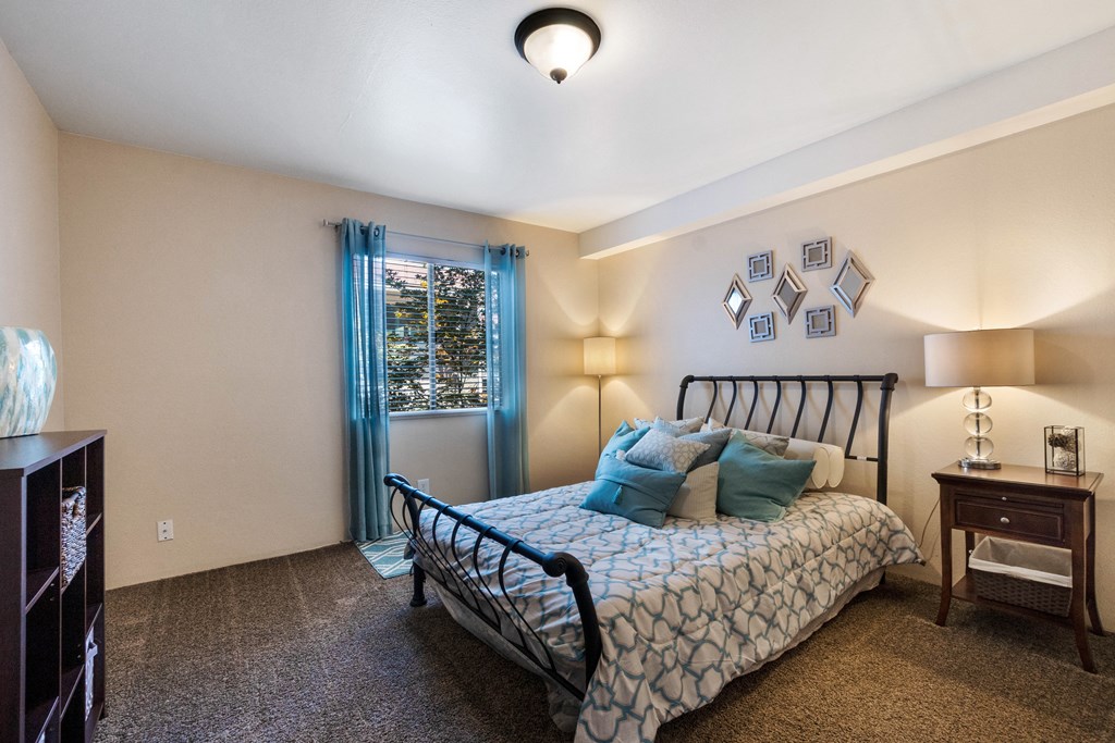 a bedroom with a bed and a window