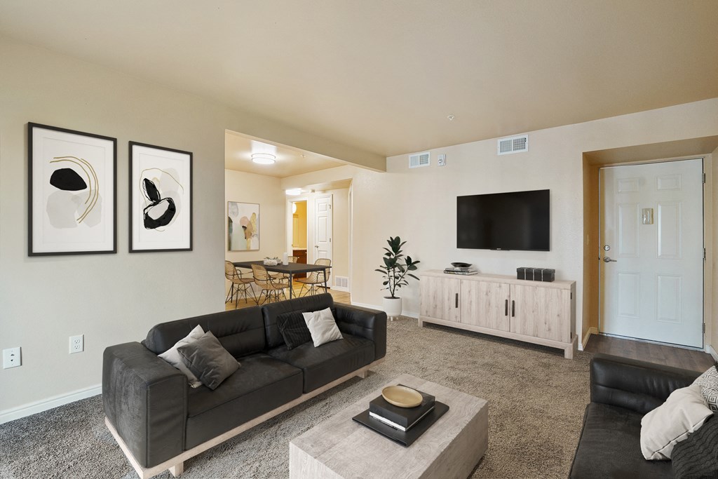 an open living room with a couch and a tv