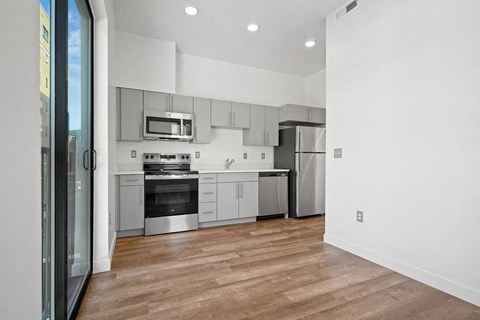 a kitchen with white cabinets and stainless steel appliances