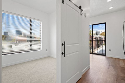 a large white door in a room with a large window