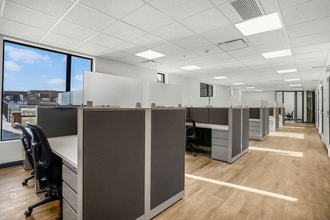 A long hallway with cubicles on both sides.