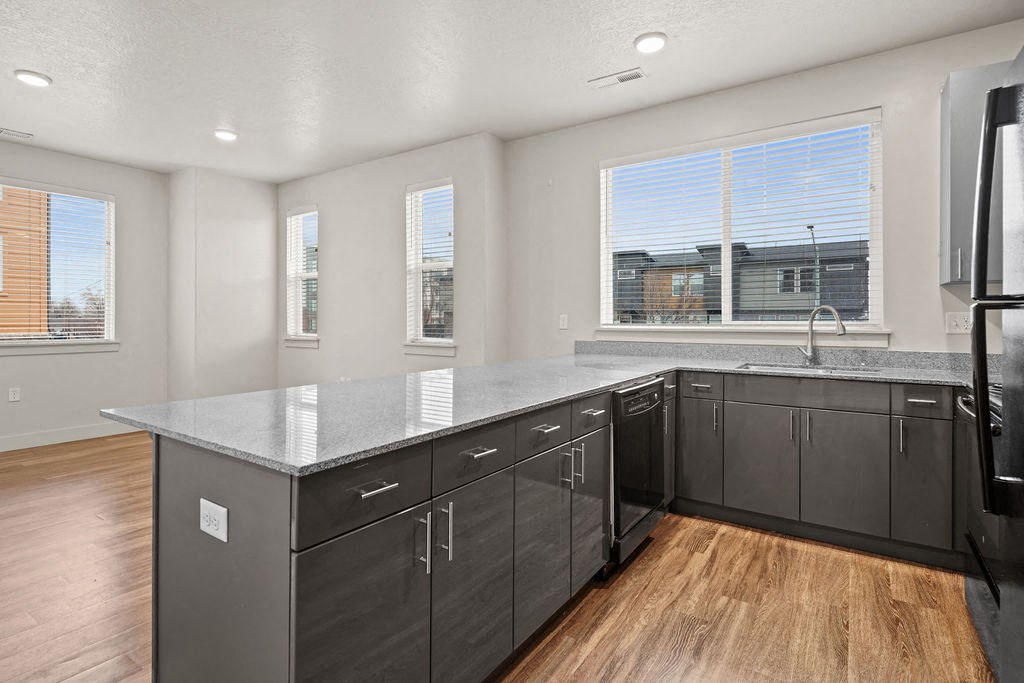 A kitchen with a large island and stainless steel appliances.