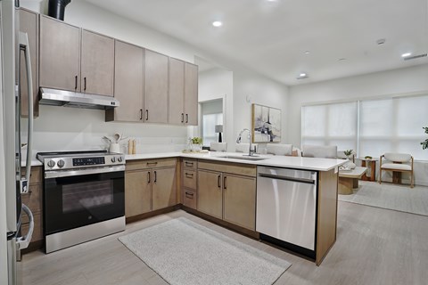 A modern kitchen with a stainless steel refrigerator and a white oven.
