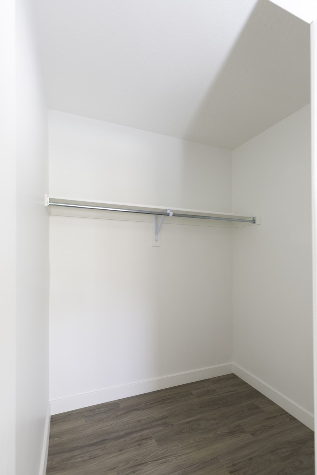 an empty room with a white wall and a white shelf on the wall
