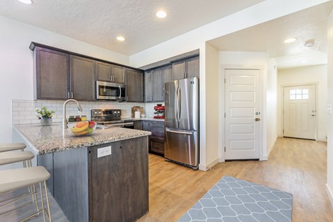 a kitchen with stainless steel appliances and a granite counter top