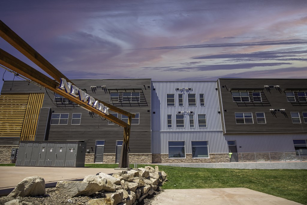a row of apartment buildings with a sign in front of them