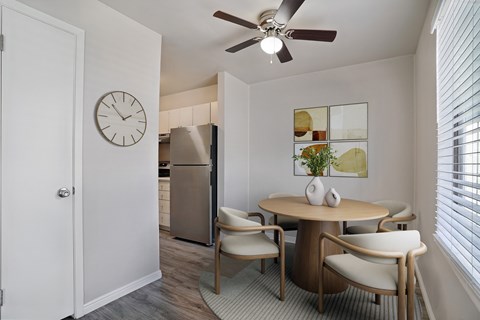 A dining room with a table and chairs.