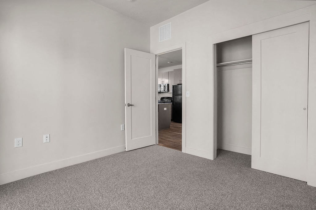 A room with a white door and a white wall.