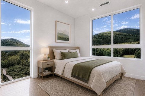 A bedroom with a large bed and a view of the mountains.