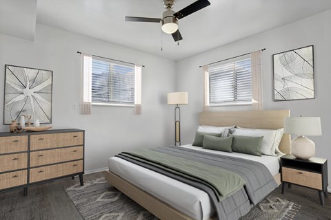 A bedroom with a bed, nightstand, and a dresser.