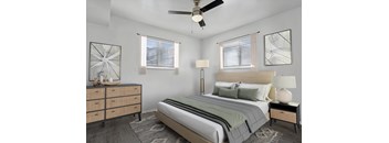 A bedroom with a bed, nightstand, and a dresser.